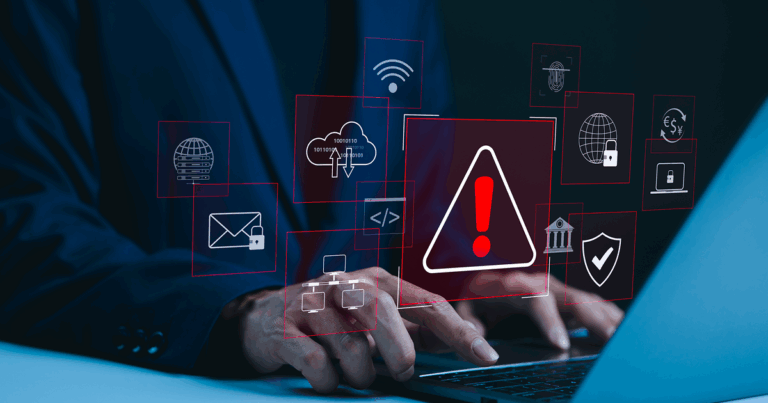 A person's hands typing on a keyboard with a caution exclamation point sign imposed over the image to indicate cybersecurity.